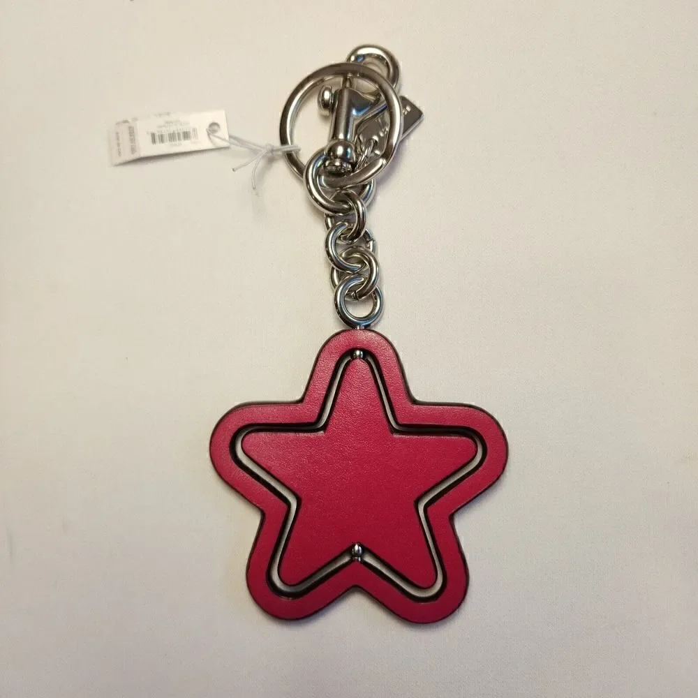 NWT Coach CP899 Spinning Star Bag Charm In Signature Canvas Bright Violet